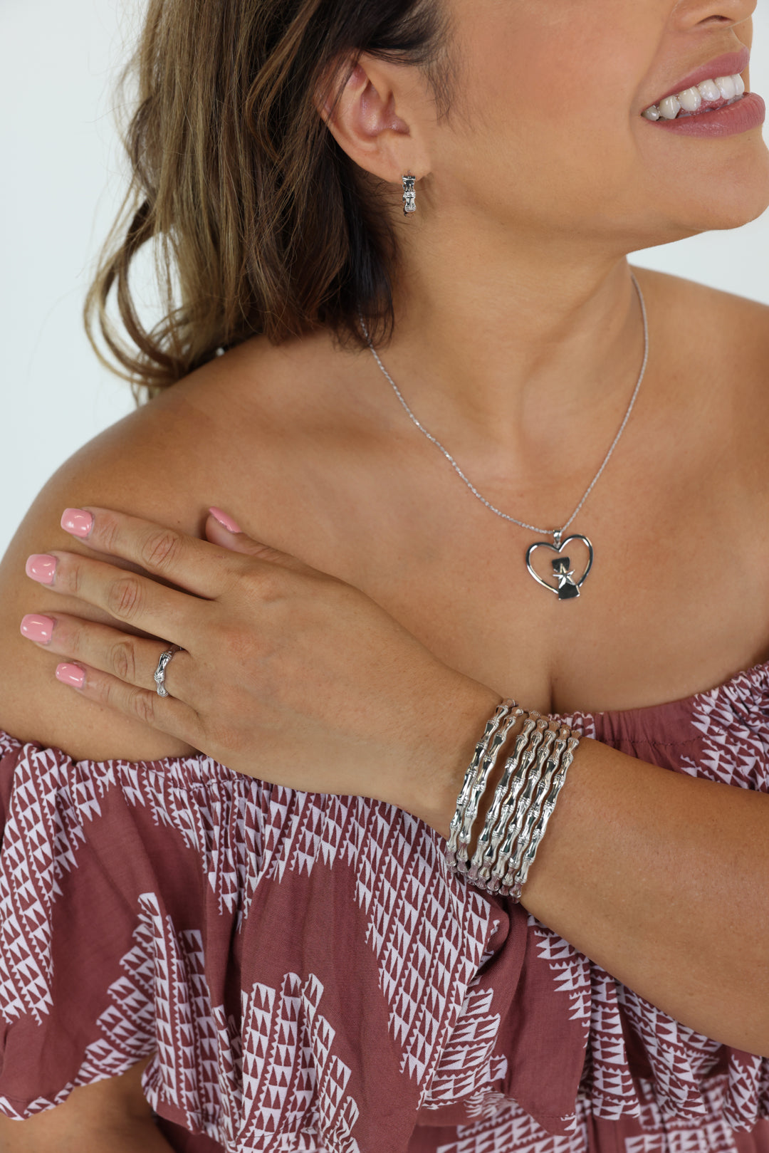 Sterling Silver and Rhodium Bamboo Design Rosa Bangle, 5mm Rosa hoop earring, 5mm Rosa ring, and CNMI heart seal necklace.